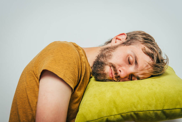 Sleep. Man against studio background - Фото, изображение
