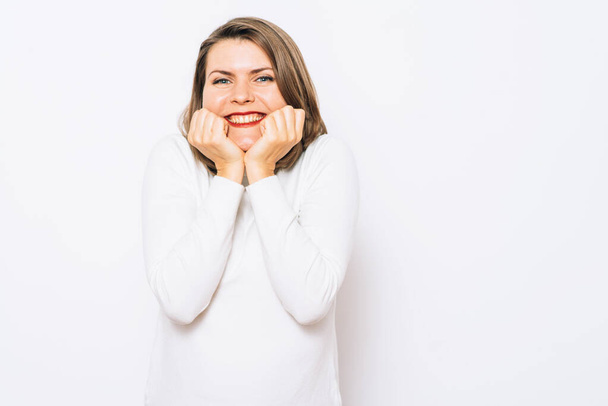 Woman smiling against studio background - Photo, Image