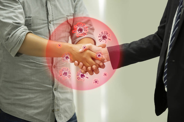 Covid-19 and Coronavirus ,Virus in hands concept.Business people shaking hands traditional in Europe with coronavirus.Concept for wash hands first. Covid19 coronavirus and pandemic virus symptoms. - Photo, Image
