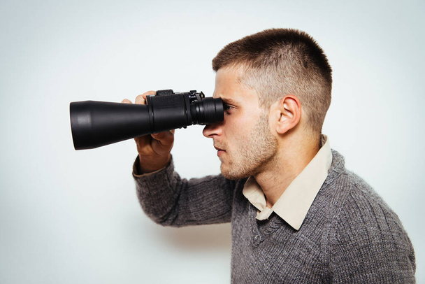 man with binoculars. gray background - Foto, Imagem