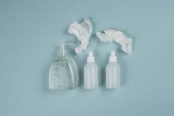transparent bottles of antiseptic And soap isolated on a blue background. quarantine for Coronavirus covid-19. Concept of hygiene - Photo, Image