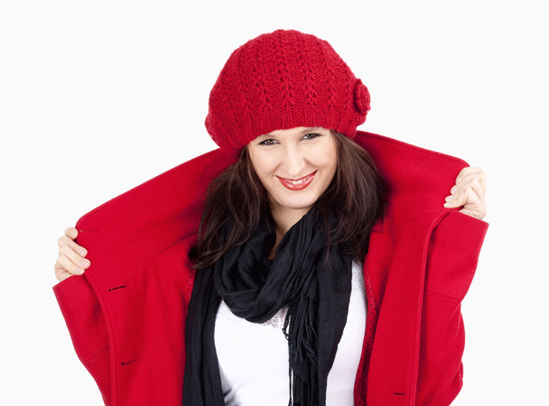 赤いコートおよび帽子笑顔で若い女性 - 写真・画像