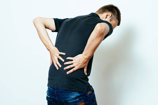 man with backache in photo studio - Φωτογραφία, εικόνα