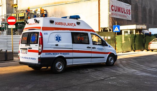 Romanian ambulance car, 911 or 112 emergency medical service in mission in downtown Bucharest, Romania, 2020. Coronavirus worldwide outbreak crisis. Spread of the COVID-19 virus - Photo, Image