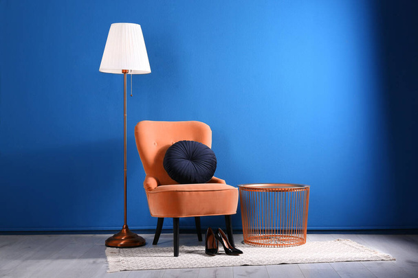 Comfortable orange armchair with cushion in stylish room interior - Photo, Image