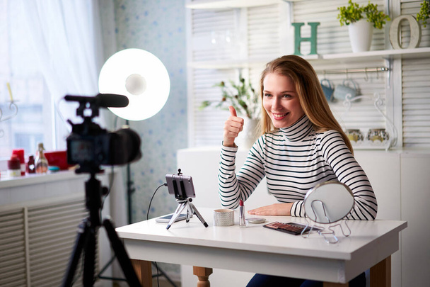 Caucasian female beauty blogger showing thumbs up with positive emotions, happiness. Satisfaction with quality and recommendation of cosmetics products. Makup artist asks to like, follow her channel - Fotografie, Obrázek