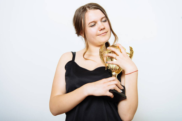 Woman with a golden cup - Фото, изображение