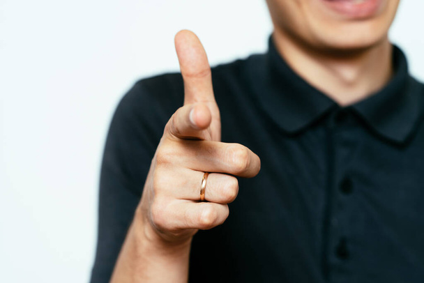Young man showing his index finger towards the camera - Foto, imagen