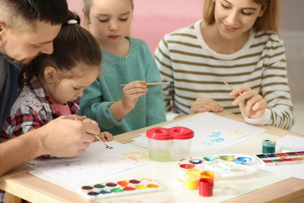 Lovely family painting at table indoors. Playing with children - Foto, imagen