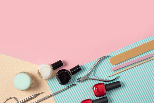 Tools for manicure on a pink and blue background. Nail files, scissors and nail polishes top view. Nail Salon, Beauty Salon. - Φωτογραφία, εικόνα