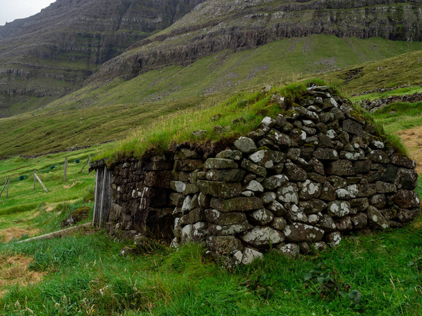 Faroe Islands. Muli Village. Old stone house with grass roof. - 写真・画像