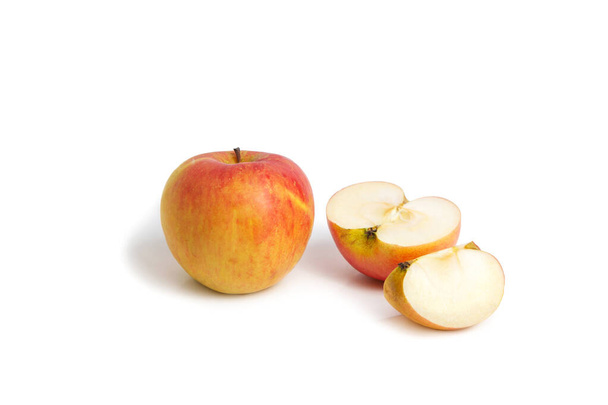 Whole, half and quarter apple on a white isolated background. Fresh fruits. Vegetarian food. - 写真・画像