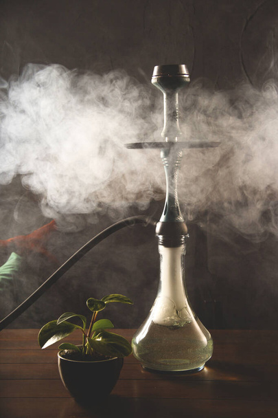 Harmful habit of smoking a hookah in a bar for relaxation concept. - Φωτογραφία, εικόνα