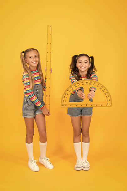 STEM school disciplines. Geometry set with ruler and protractor. little schoogirls yellow background. happy children love math. physics and mathematics. Geometry favorite subject. education - Фото, зображення