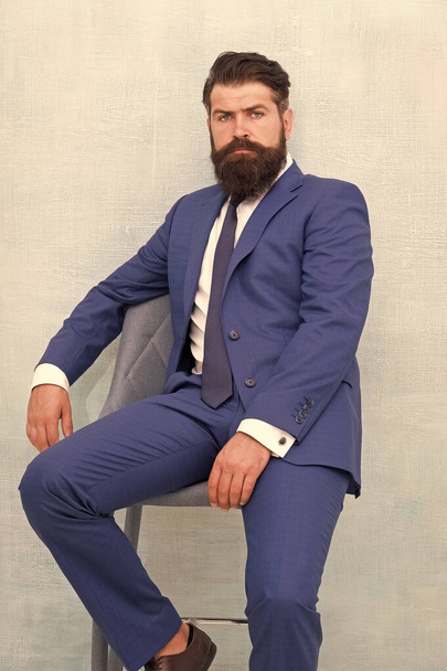 He is sure to impress. Confident businessman. Businessman sit on chair. Bearded businessman in formal style. Businessman with beard and mustache hair. Smart and professional look. Business dress code - Foto, Imagem