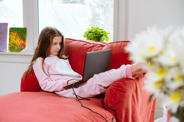 Preteen girl enjoyes homeschooling. Remote education and lockdown concept - Photo, Image