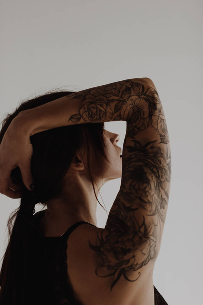 Beautiful young woman with tattoo on hand - Φωτογραφία, εικόνα