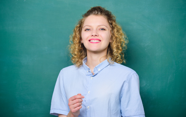 Passionate about knowledge. Teaching could be more fun. Teacher explain hard topic. Teacher best friend of learners. Good teacher is master of simplification. Woman teacher in front of chalkboard - Photo, Image
