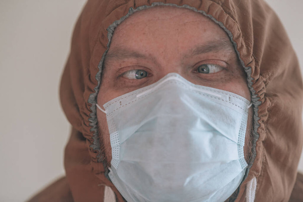 Человек в защитной маске. Портрет человека в бумажной маске, защита и гигиена от вирусов. Концепция коронавируса-2020
 - Фото, изображение