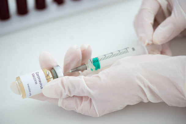 Test tubes with blood sample Covid-19 coronavirus. Vaccine and syringe injection It use for prevention, immunization and treatment from COVID. - Foto, Imagem