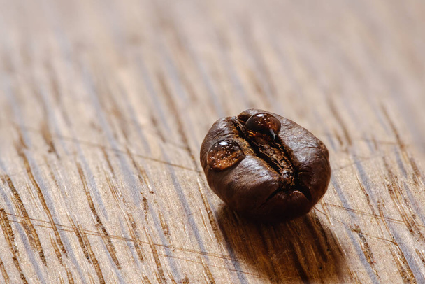 shiny fresh roasted coffee macro beans on wooden background close up - Photo, Image