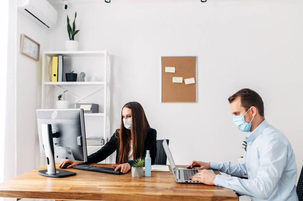 Office workers in medical masks during pandemia - Fotó, kép