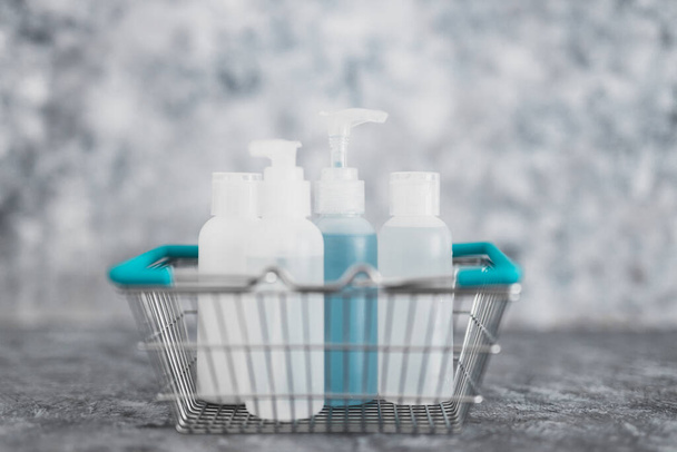 importance of hygiene to slow the spread of germs and viruses, shopping basket fully of mixed sanitizers and cleaning supplies symbol of cleaning hands and surfaces to flatten the curve - 写真・画像