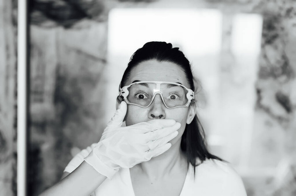 Cute girl shows how to wear a protective mask and glasses - Φωτογραφία, εικόνα