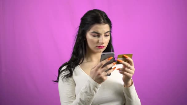 Young woman making card payment through mobile phone online banking green screen - Video
