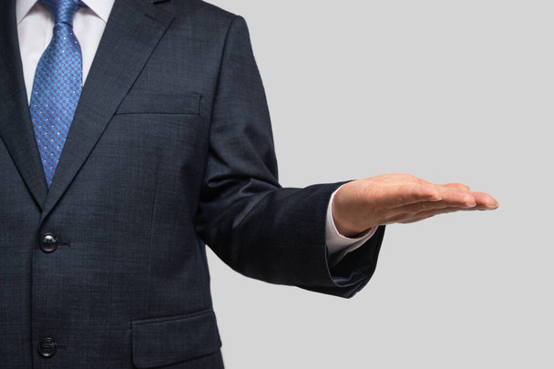 A businessman holding his palm. With copy space. - Photo, Image
