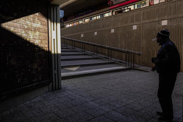 Stockholm, Sweden  A pedestrian and a strong beam of sunlight and shadow in the Bredang suburb. - 写真・画像