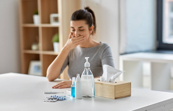 medicines and sick woman coughing at home - Foto, afbeelding