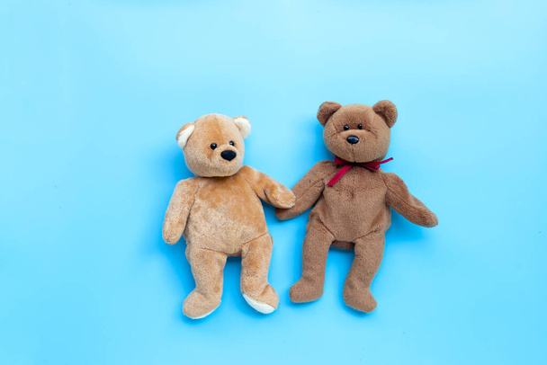 Bear toy couple on blue background. Copy space - Photo, Image