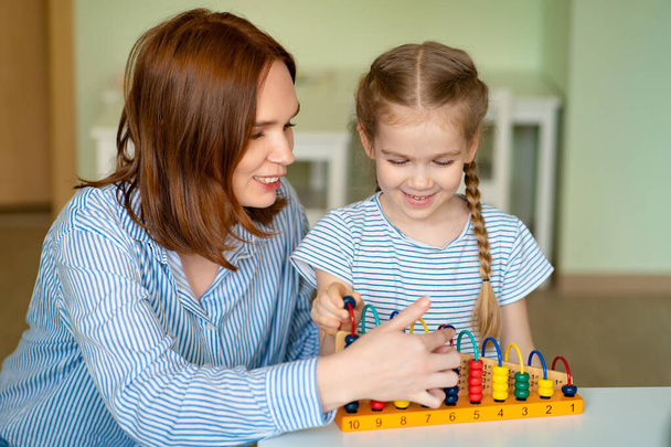 mother with girl learning to add and subtract - Photo, Image