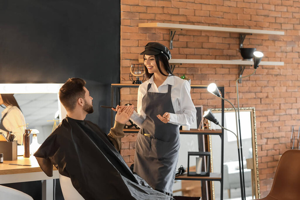 Hairdresser working with client in salon - Photo, Image