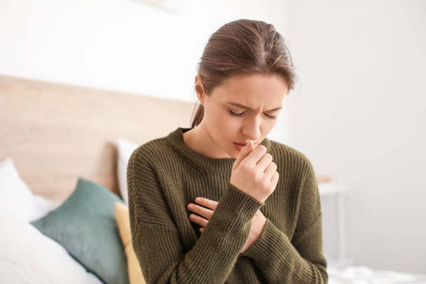 Ill woman coughing at home - 写真・画像