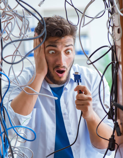 Electrician trying to untangle wires in repair concept - Photo, Image
