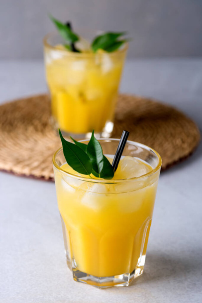 Tasty and Refreshing Orange Juice in Glasses with Black Straws on Light Gray Background Fresh Ripe Oranges Vitamin or Detox Drink Vertical - Foto, imagen