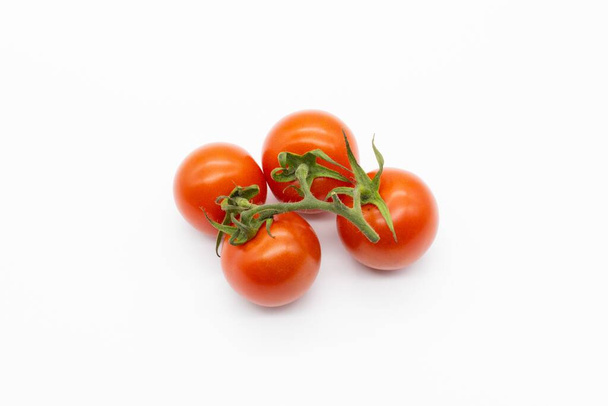 The four cherry tomatoes isolated on a white background - 写真・画像