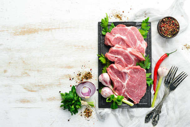 Raw veal meat with parsley and spices on the table. Beef steak. Top view. Free space for your text. Rustic style. - Photo, Image