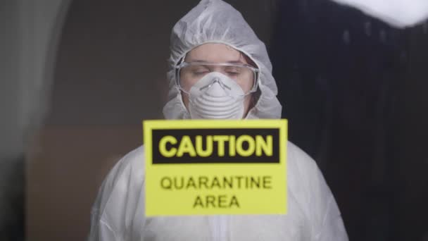 woman in protective suit in quarantine zone. Coronovirus and isolation concept - Кадри, відео