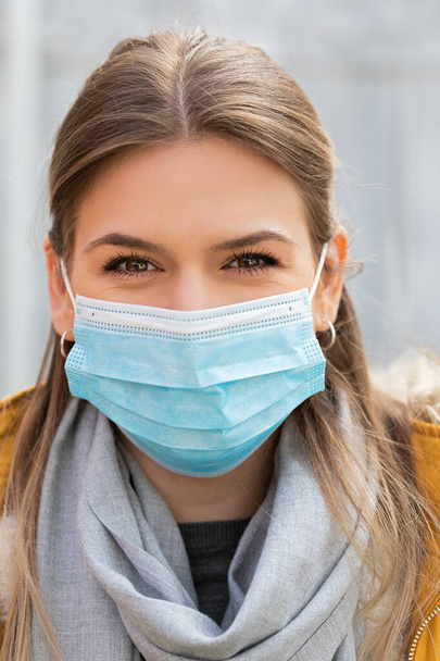 Portrait of young woman wearing protective mask - coronavirus pandemic alert - Photo, Image