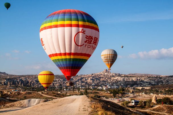 Goreme/Nevsehir, Turkey - 27 September 2019: Colorful hot air balloons flying over the valley at Cappadocia, Anatolia, Turkey. Volcanic mountains in Goreme national park. - Fotó, kép