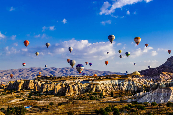 Goreme/Nevsehir, Turkey - 27 September 2019: Colorful hot air balloons flying over the valley at Cappadocia, Anatolia, Turkey. Volcanic mountains in Goreme national park. - Fotografie, Obrázek
