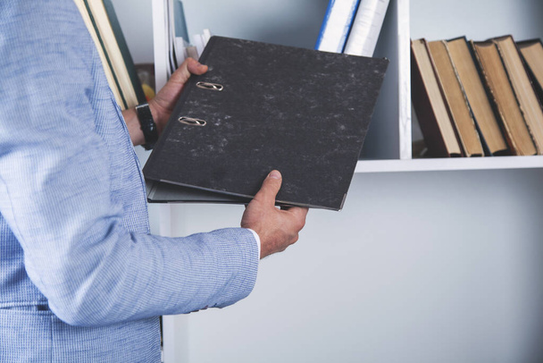 young business man hand holding files  in office - Photo, image
