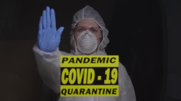 woman in protective suit in quarantine zone. Coronovirus and isolation concept - Кадри, відео