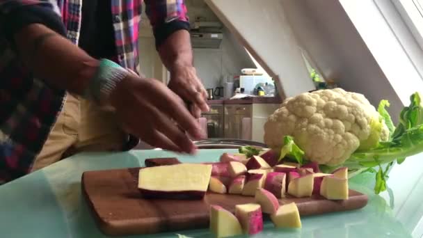 person preparing veggies in kitchen - Кадри, відео