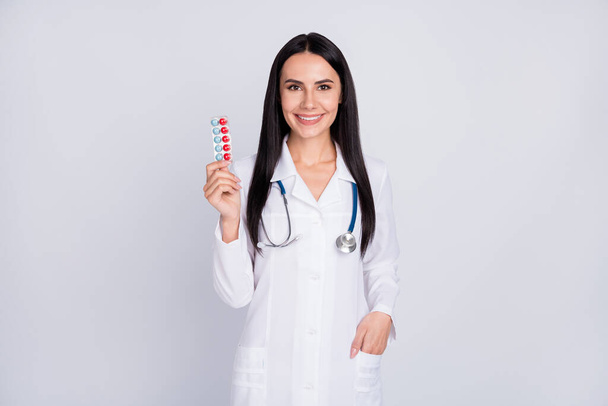 Photo of beautiful professional doc lady proposing best pills vitamin c prophylactic winter tablets wear stethoscope white lab coat isolated grey color background - Foto, afbeelding