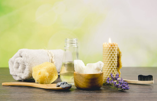Using natural material products in home, different cosmetic products in bathroom. Minimizing ecological footprint concept. Bamboo bath towel, biodegradable bamboo toothbrush, clay mask, coconut oil. - Photo, Image