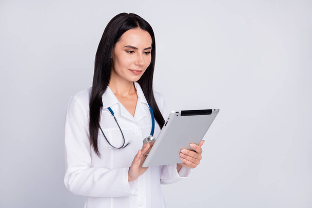 Photo of beautiful professional doc lady writing patient digital contract insurance in e-book modern technology concept wear stethoscope white lab coat isolated grey color background - Photo, Image